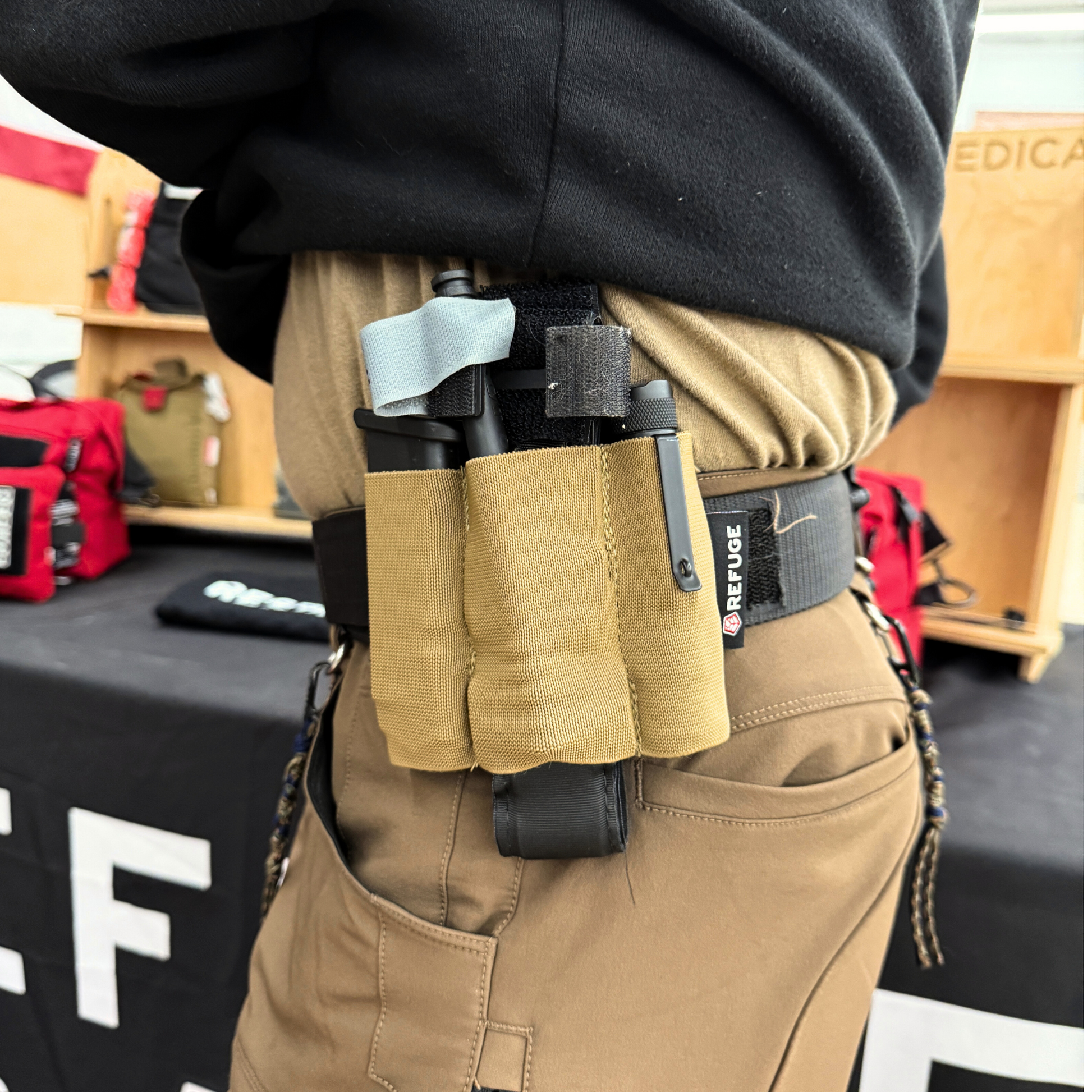 Refuge Medical Pocket Organizer - Coyote Tan on a belt packed with magazine, tourniquet, and flashlight (components not included)
