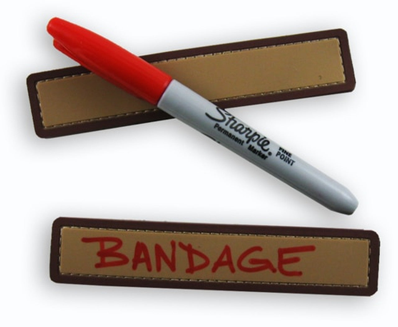 A tan-colored PVC name tape with a brown border, accompanied by a red Sharpie marker. The name tape has the word 'BANDAGE' written on it.