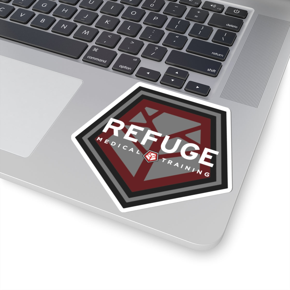 Refuge Medical logo sticker 4" x 4" on a laptop
