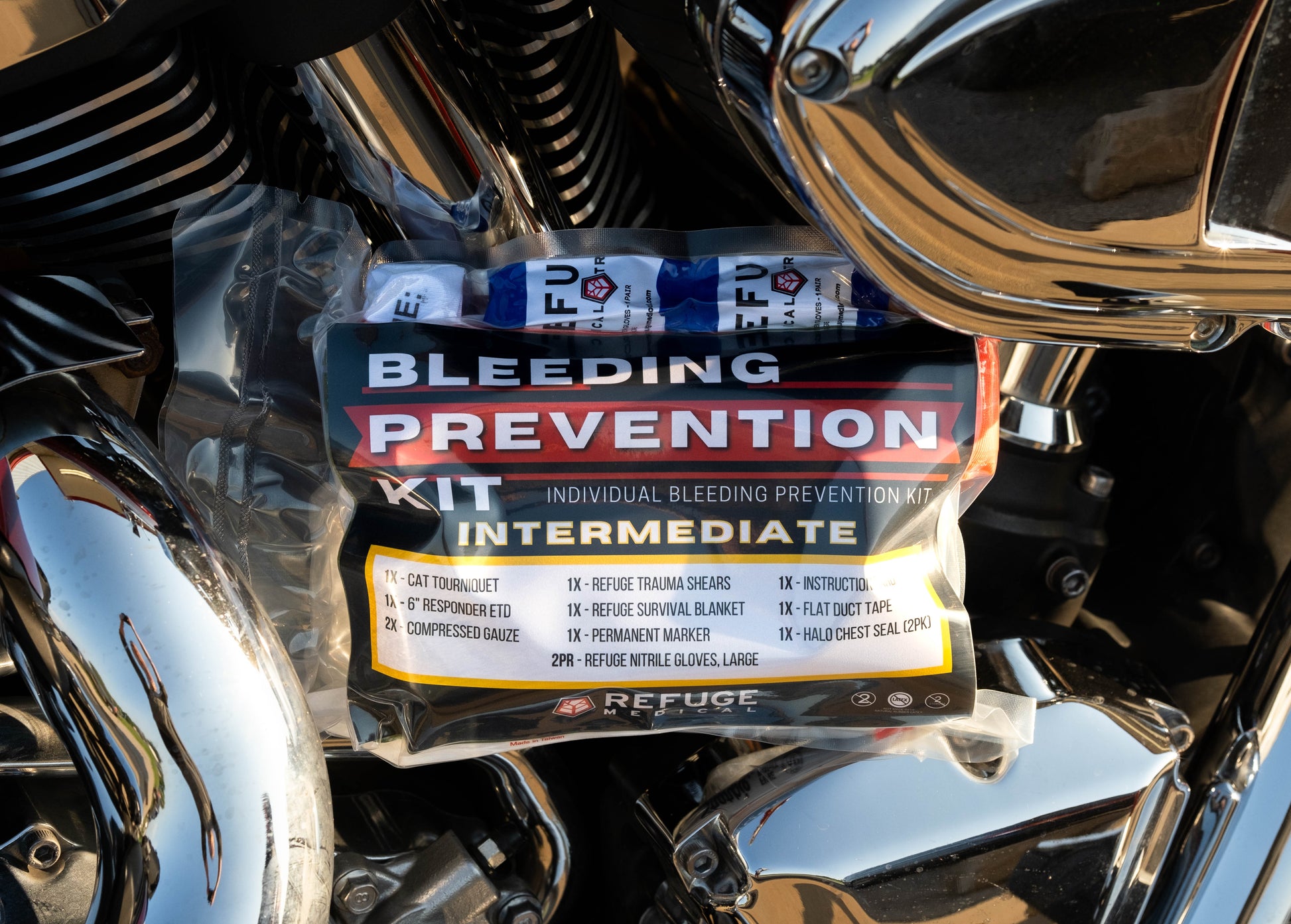 Refuge Medical Bleeding Prevention Kit Vacuum Sealed First Aid Kit - Intermediate staged on a motorcycle