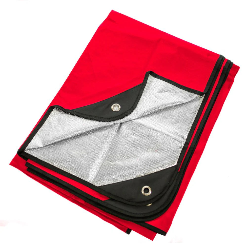 A red survival blanket with reverse reflective silver back and black reinforced tie-down grommets, displayed on a white background.