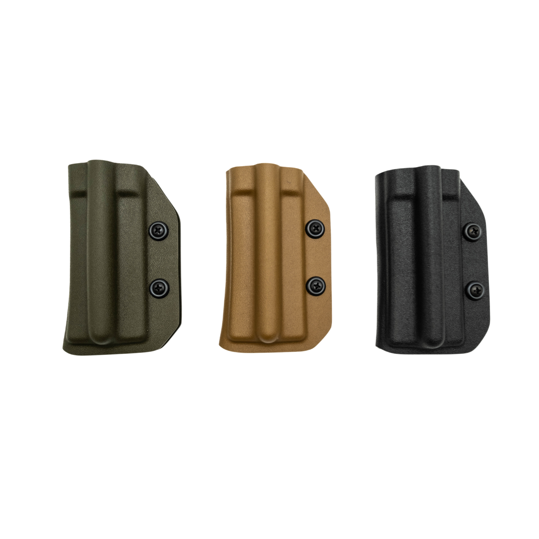 Three Kydex tourniquet holsters in black, coyote, and green colors, displayed vertically and isolated on a white background.