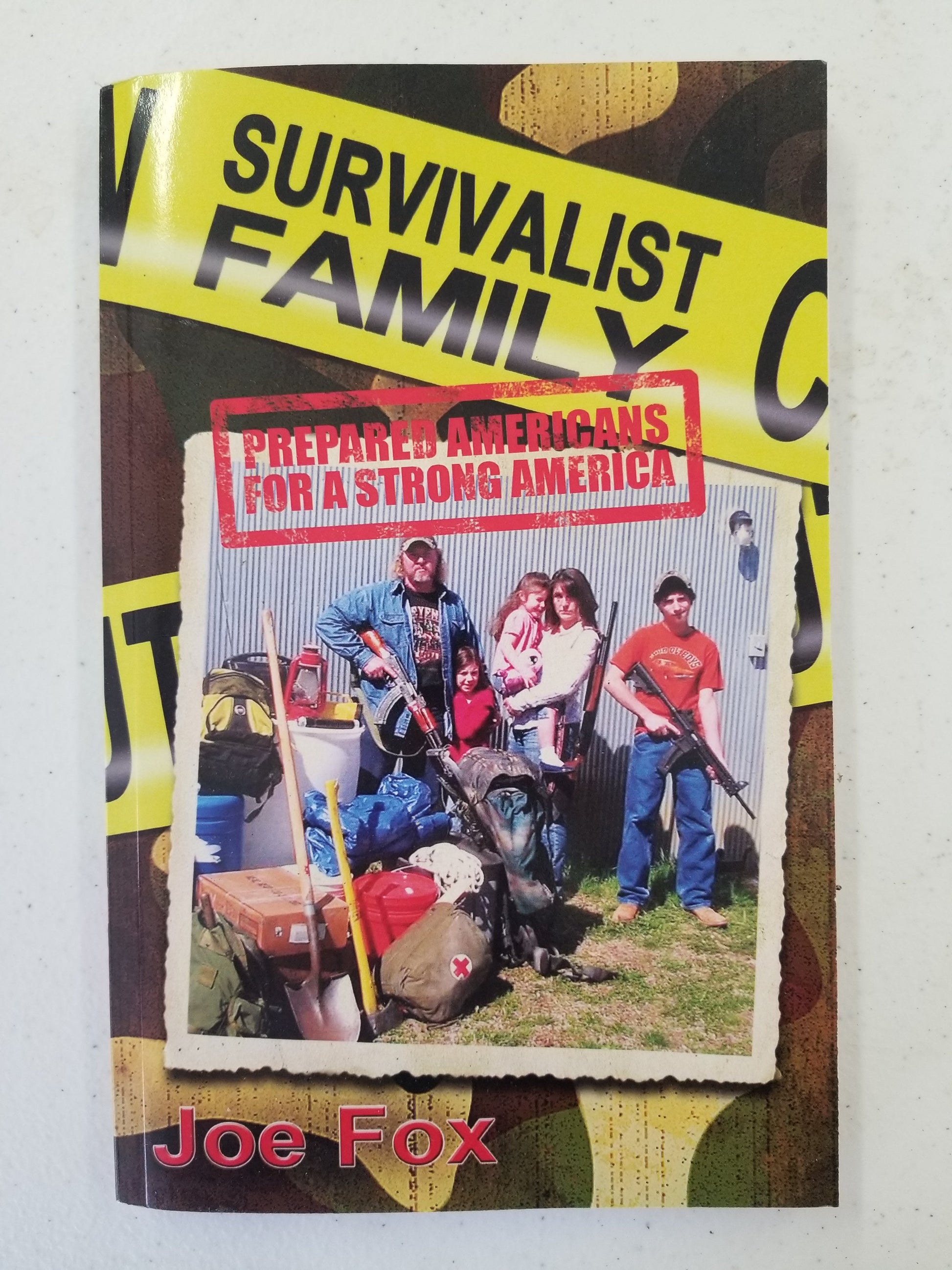 The cover of the 'Survivalist Family Book' featuring an image of a family with outdoor gear, including a camouflage jacket and hats, and a background suggesting an outdoor setting. The title and author's name, Joe Fox, are prominently displayed.